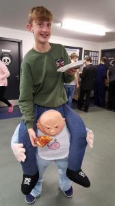 Evan feeding his baby brother